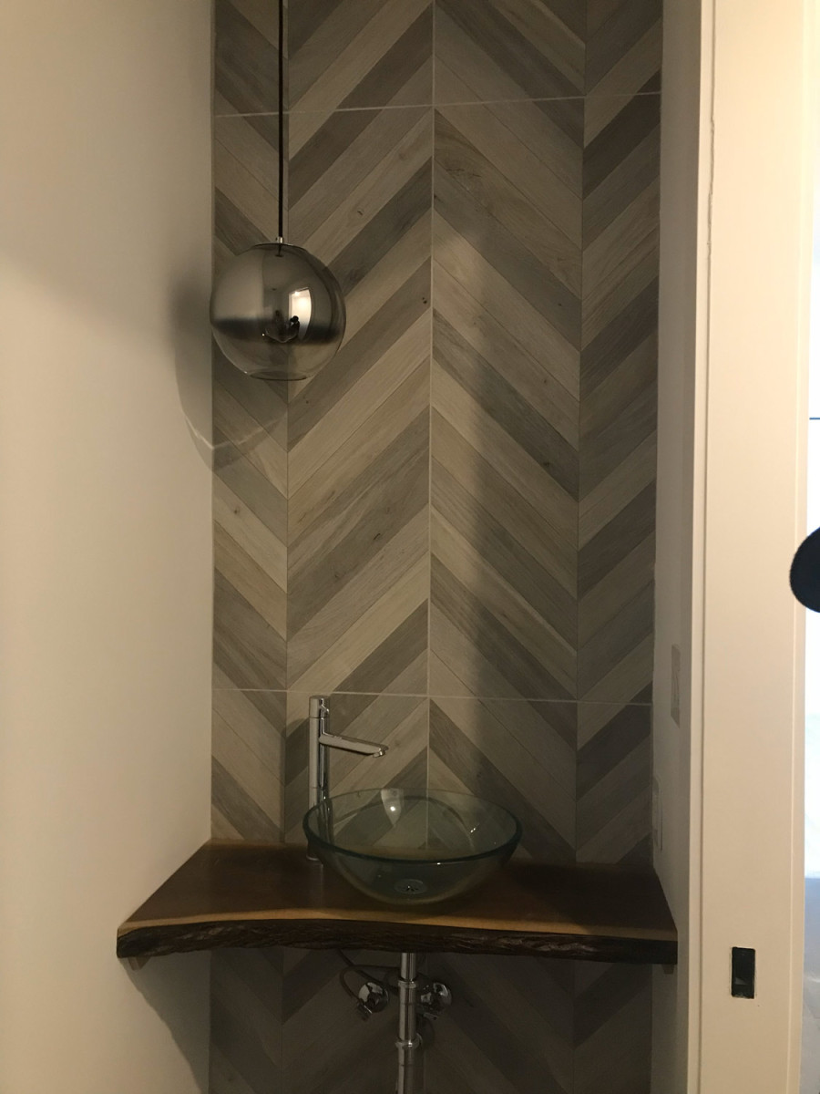 Small bathroom with tiled walls and a compact sink