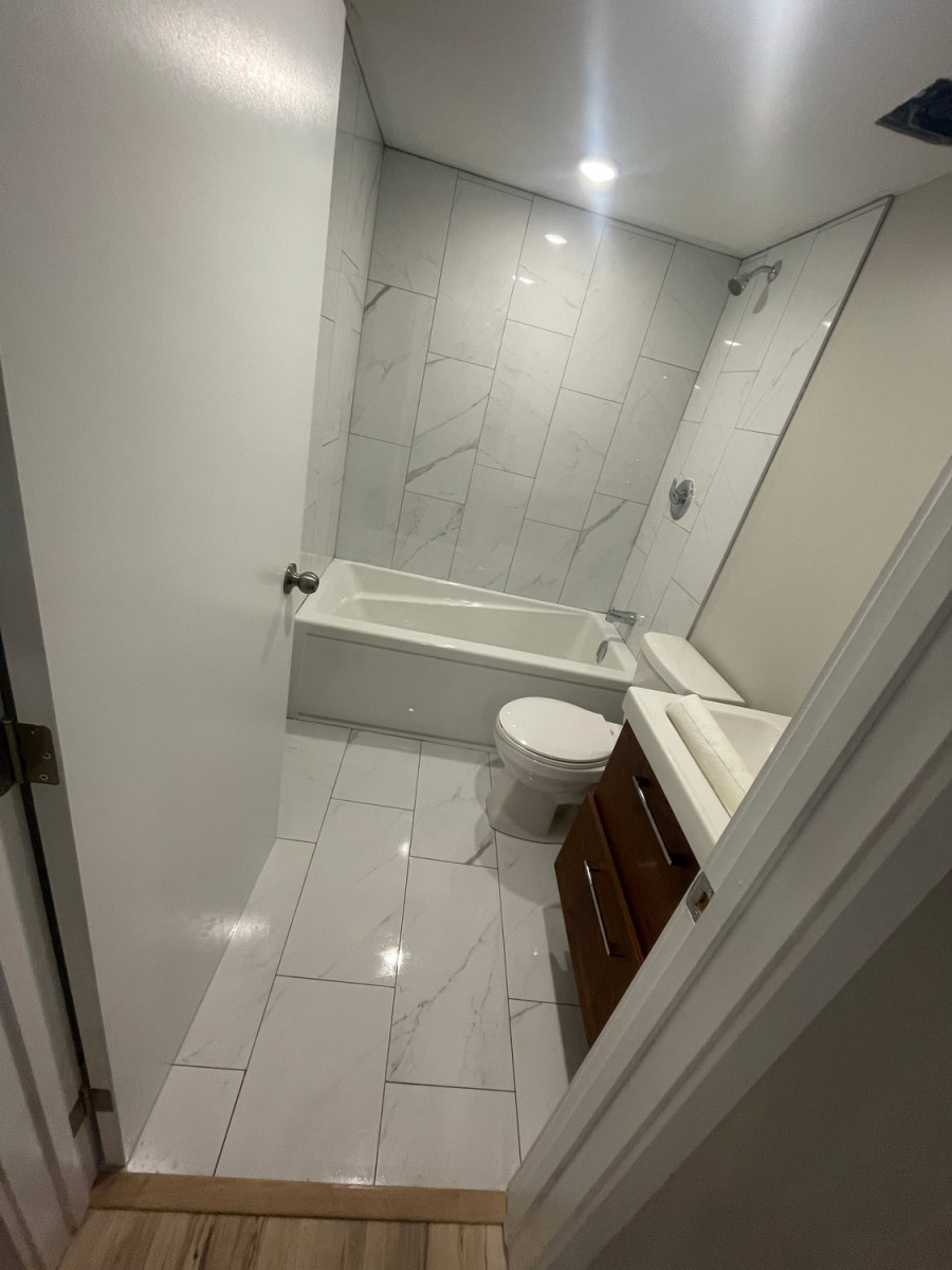Bathroom with under-vanity lighting and modern faucet designs