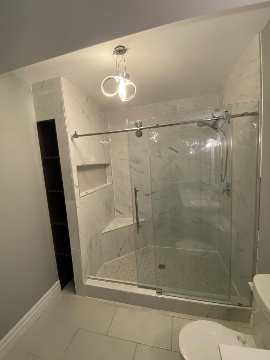 Modern white bathroom with a freestanding tub and large mirror