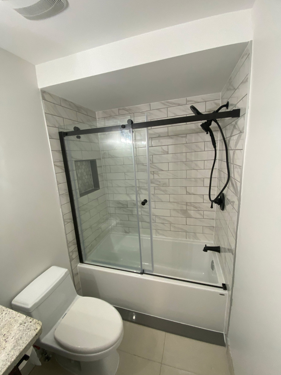Small bathroom with patterned tiles and a wall-mounted sink