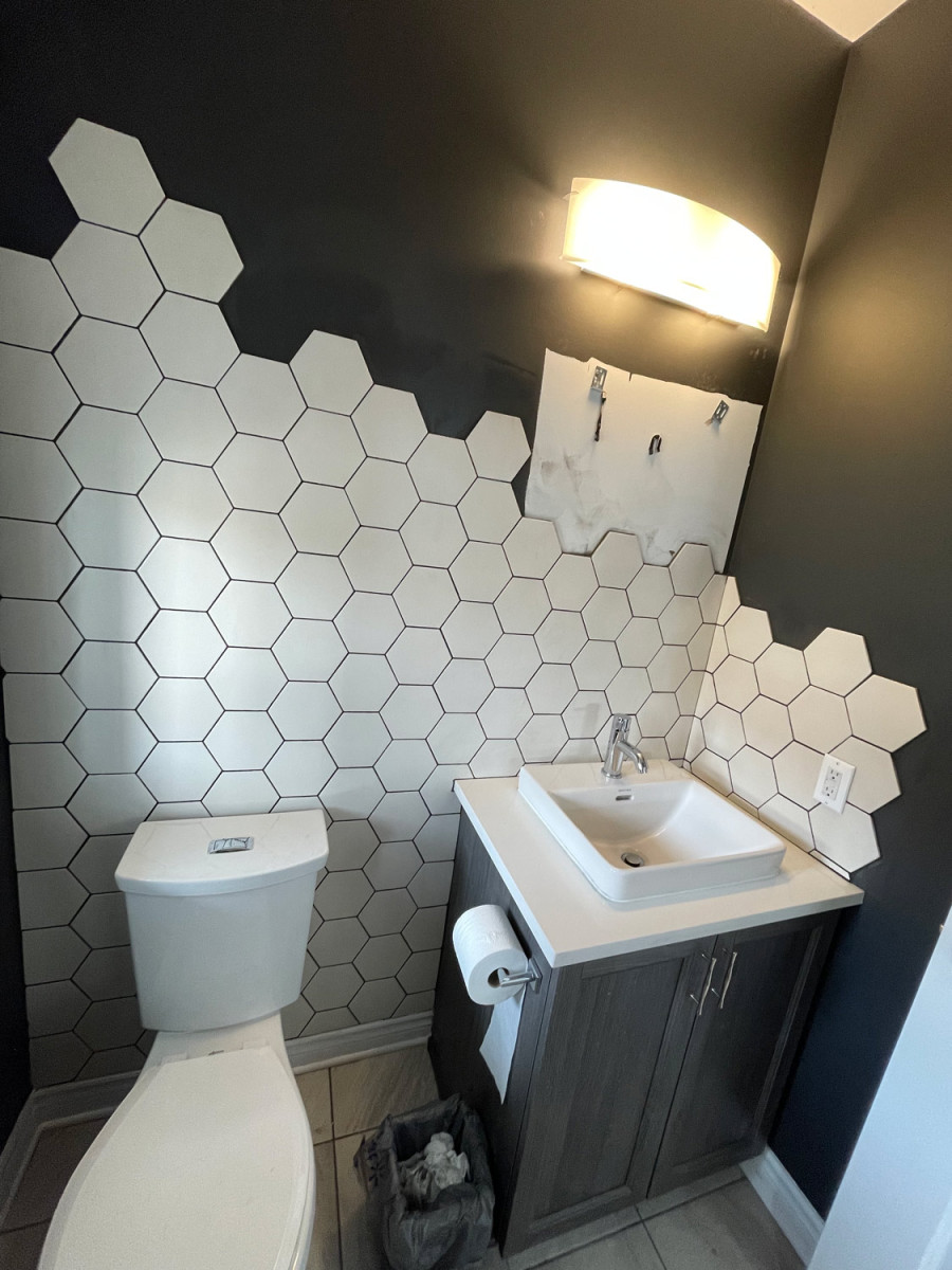 Bathroom with bold wallpaper and a unique vessel sink