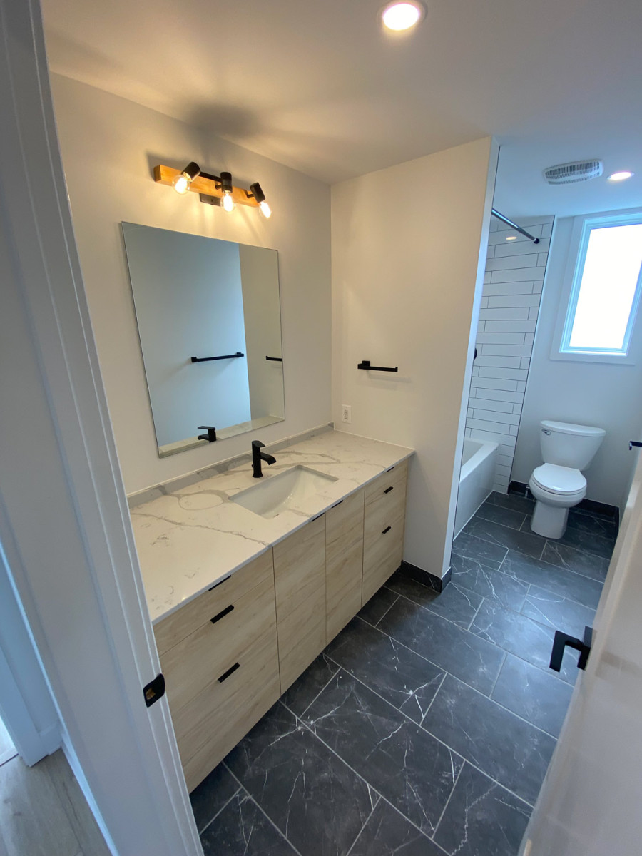 Bright bathroom with a skylight and white subway tiles