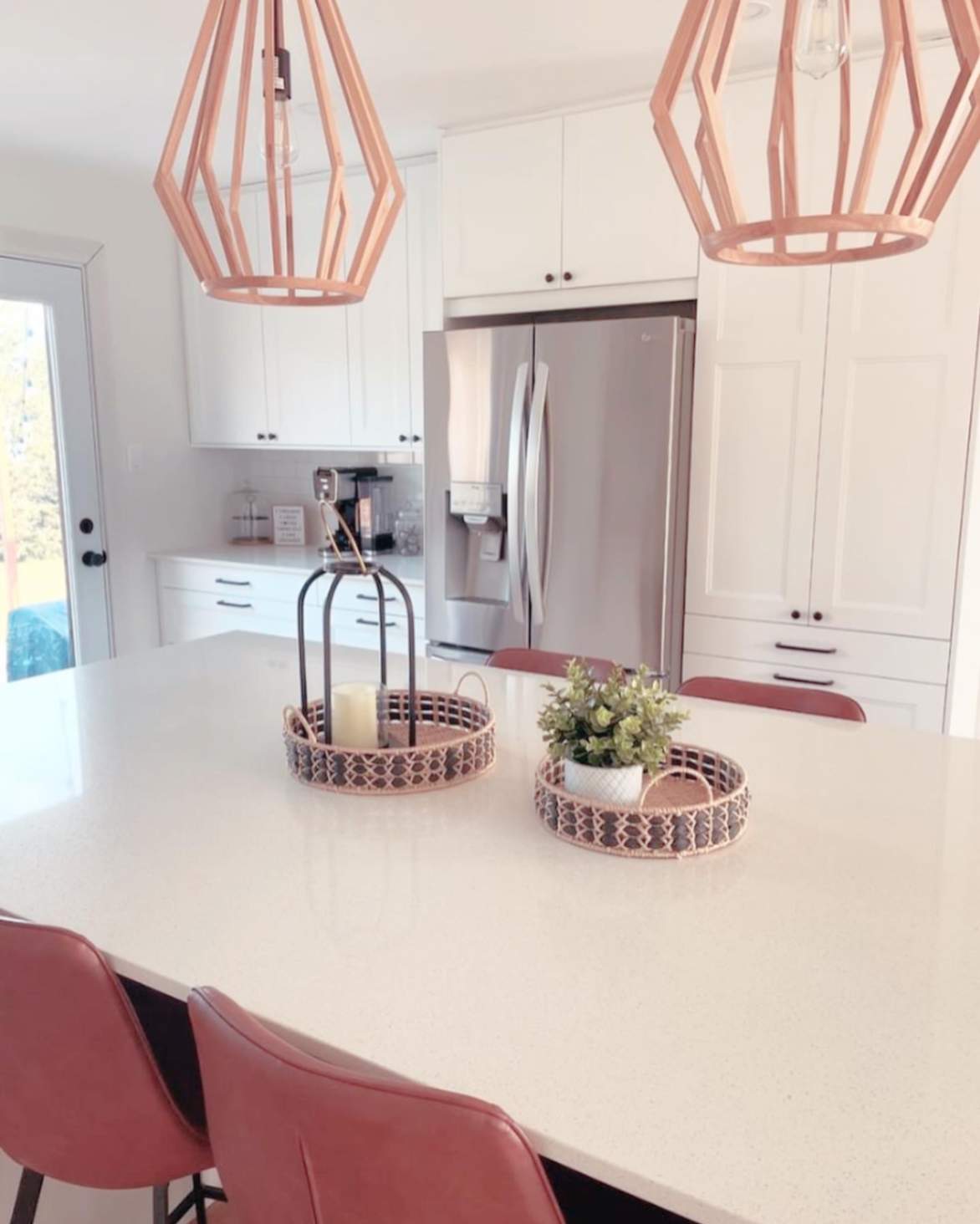 Modern Ottawa kitchen and dining room renovation with white cabinetry, wood flooring, pendant lighting, and open-concept dining area